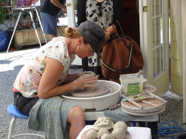 Carolyn MacLaren demonstrating on pottery wheel at Birthplace of B.C. Gallery